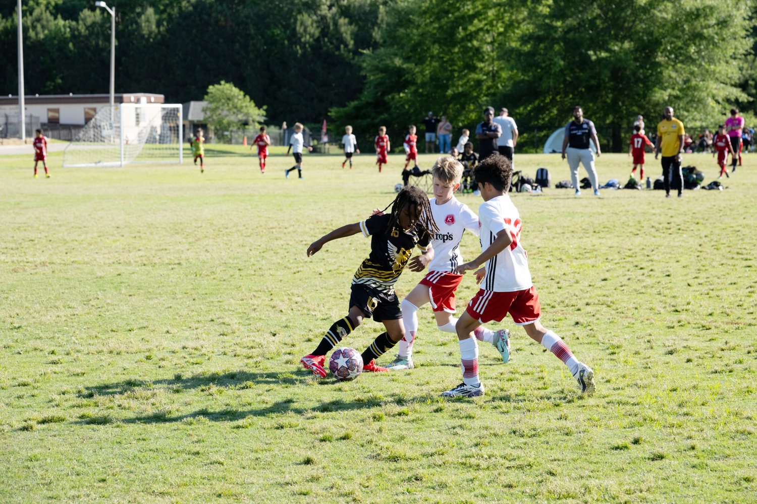 Young players battling for the ball in a weekend game