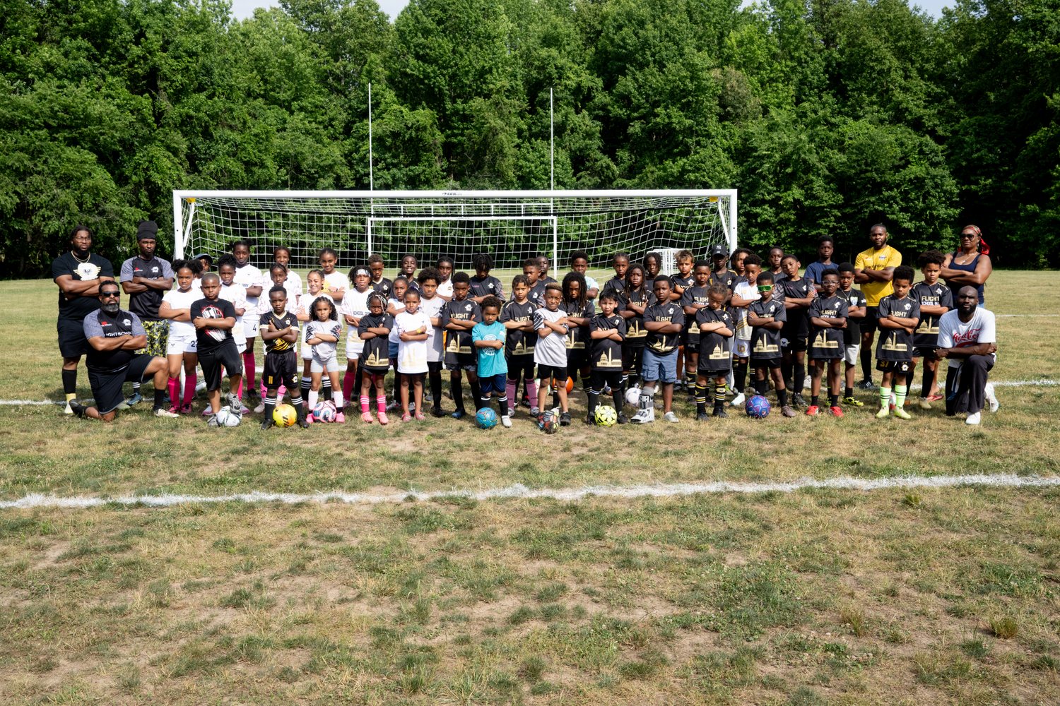 The whole Flight School Project club together in front of the goal